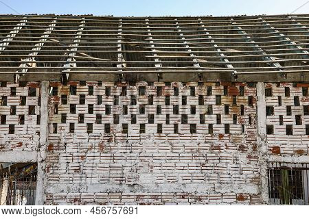 Wall With Exposed Bricks, In The Color Of Clay, With A Light White Paint Already Faded By Time. Abov