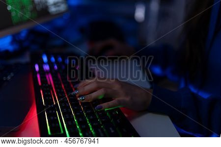 Close-up Of Woman Hacker Hands At Keyboard Computer In The Dark Room At Night, Cyberwar Concept. Sid
