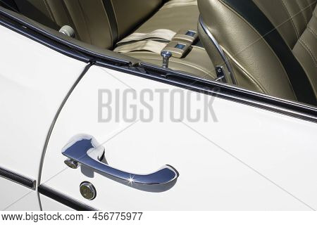 Fragment Of A White Classic Car With A Side Door, Door Handle And Seats