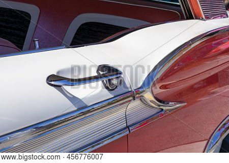 Fragment Of Red And White Classic Car With Chrome Details And Door Handle And Lock