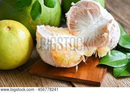 Fresh Green Pomelo Peeled And Leaf Frome Pomelo Tree , Pomelo Fruit On Wooden Plate  Background, Pum
