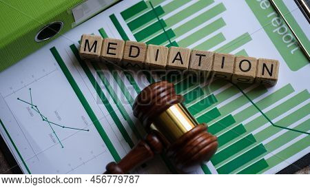 Top View Of Wooden Cubes With Word Mediation And Judge Gavel On Documents. Retrial Settlement Of Dis