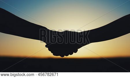 Handshake Farmers Silhouette. Agriculture Business Concept. Close-up Farmers Hands Silhouette Shakin