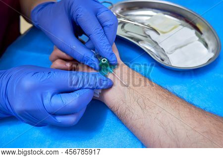 Preparation For Vein Catheterization. Intravenous Catheter In Doctor's Hands
