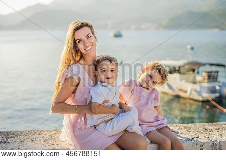Mother And Two Children Daughter And Son Tourists On Background Of Beautiful View St. Stephen Island