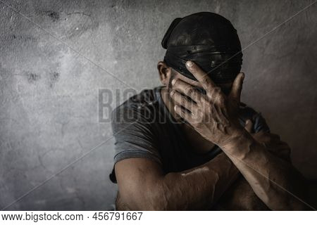 Men Who Show Stress And Loneliness, Homeless Man Drug  Addict Sitting Alone And Depressed  At An Aba