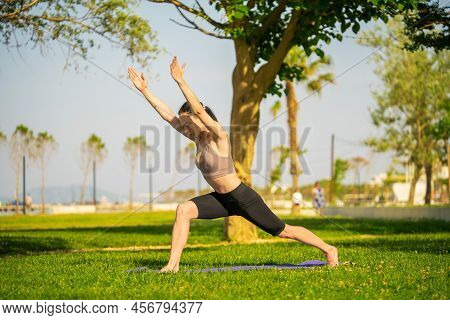 A Woman In Brown Sport Bra And Black Short Sitting On Yoga Mat Doing Maditation With Hand Together A