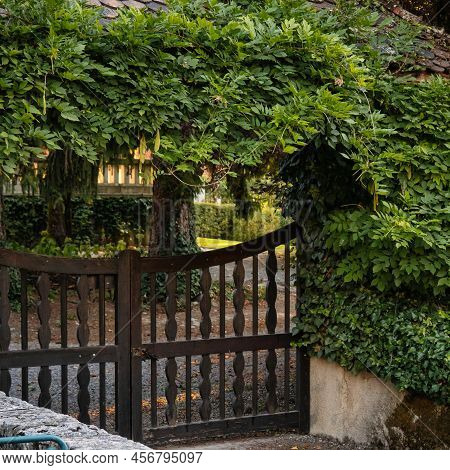 Talloires, France - September 08 2020 : A Green Pergola Or Arbor Is Formed Above The Entrance Gate O