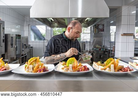 Chef Is In Final Touch Process Of Preparing Fine Dining Food Table For A Party On A Professional Res