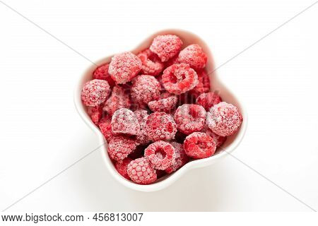 Frozen Organic Raspberry In White Bowl On White Background. View From Above.