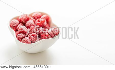 Frozen Ripe Raspberry In White Bowl On White Background. Selective Focus. Copy Space.