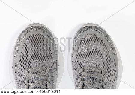 New Unbranded Running Sneaker Or Trainer On White Background. Men's Light Grai Sport Footwear. Close