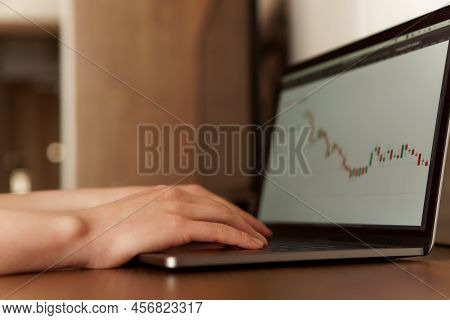 Female Hands Typing Numbers On Laptop. Investment Analysis, Trading Concept. Technology, Digitalizat