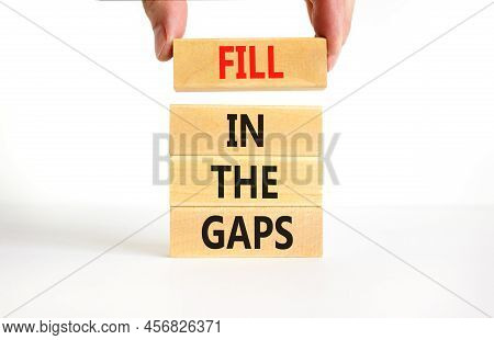 Fill In The Gaps Symbol. Concept Words Fill In The Gaps On Wooden Blocks On A Beautiful White Table 