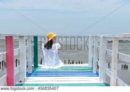 The Asian Woman Sitting On The Rainbow Bridge To See The Viewpoint At The Samut Sakorn Province, One