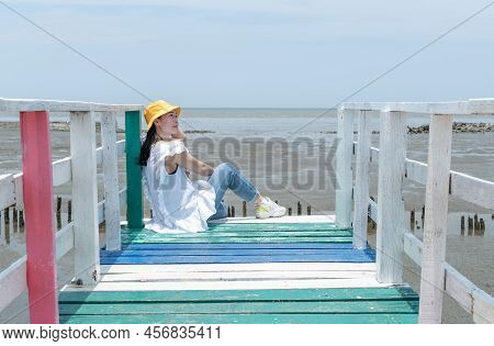 The Asian Woman Sitting On The Rainbow Bridge To See The Viewpoint At The Samut Sakorn Province, One