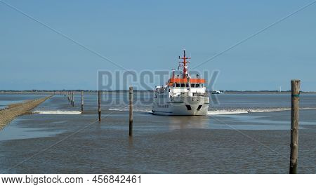 A Passenger Ferry From A Wadden Island Approaches A Harbor On The Wadden Sea
