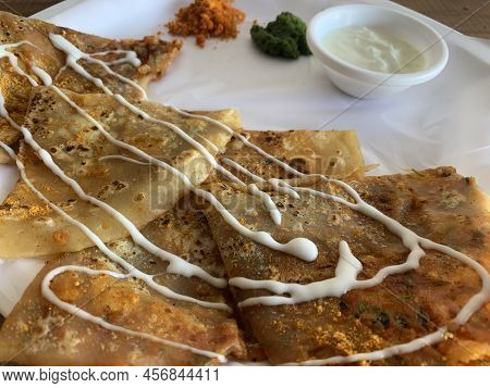 Aloo Paratha Or Indian Potato Stuffed Flatbread. Served With Fresh Curd And Chutneys. Selective Focu