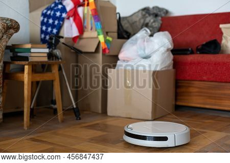 Boxes With Things To Move And Robot Vacuum Cleaner.