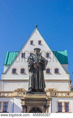 Statue Of Martin Luther In Front Of The Historic Town Hall Of Eisleben, Germany