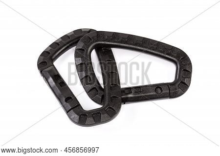 Two Small Black Strong Plastic Non-locking Snap Hooks Fastened Together On A White Background