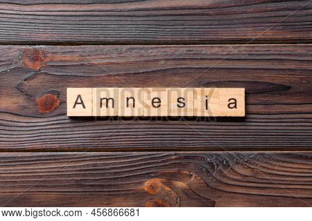 Amnesia Word Written On Wood Block. Amnesia Text On Table, Concept.