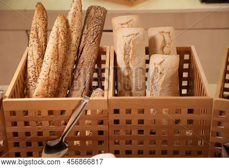 Two Baskets Contain A Wide Variety Of Baked Goods.