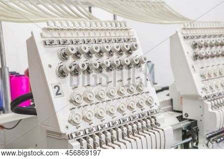 The Mechanism With The Threads Of The Embroidery Machine In The Workshop