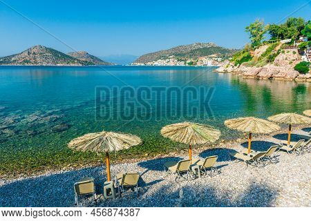 Straw Umbrellas On Sandy Sea Beach On Exotic Resort
