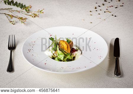 Fresh Vegetable Salad With Spices And Fish. Serving And Decorated On A White Tablecloth With A Spoon
