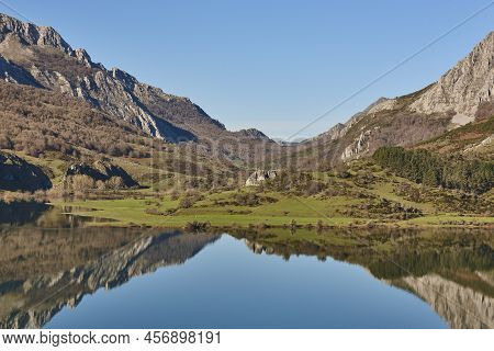 Picturesque Reservoir And Mountain Landscape In Riano. Mirror Effect. Spain
