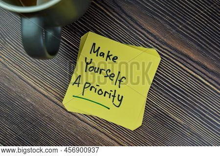 Concept Of Make Yourself A Priority Reminder Write On Sticky Notes Isolated On Wooden Table.