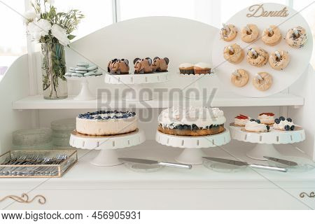 Serving Decorated Donuts, Berry Cakes, Cookies And Creamy Cupcakes On Tray, White Background. Sweet 