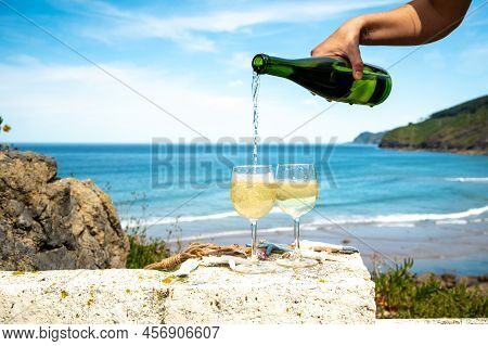 Pouring Of Txakoli Or Chacolí Slightly Sparkling Very Dry White Wine Produced In Spanish Basque Coun