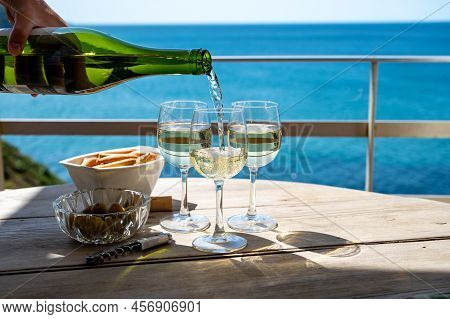 Pouring In Glasses Of Txakoli Or Chacolí Slightly Sparkling Very Dry White Wine Produced In The Span
