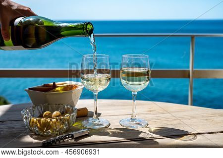 Pouring Of Txakoli Or Chacolí Slightly Sparkling Very Dry White Wine Produced In The Spanish Basque
