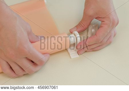 Women's Hands Are Assembling Roller Blinds, Close-up. Assembly Of Roller Blinds