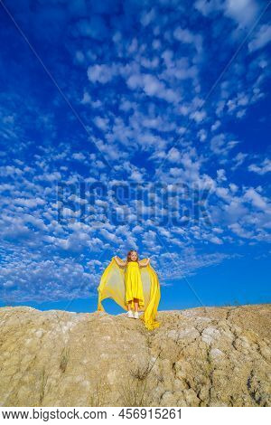 Ukrainian Patriot Girl In A Yellow Dress Against A Blue Sky. Summer Photo. Blue Sky. Sunny Day. Free