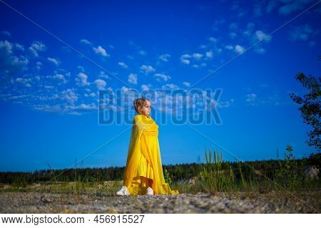 The Symbol Of Freedom Is A Ukrainian Girl Of 7 Years Old, Patriotically Dressed In A Yellow Dress Ag