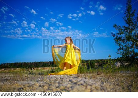 The Symbol Of Freedom Is A Ukrainian Girl Of 7 Years Old, Patriotically Dressed In A Yellow Dress Ag