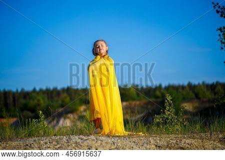 The Symbol Of Freedom Is A Ukrainian Girl Of 7 Years Old, Patriotically Dressed In A Yellow Dress Ag