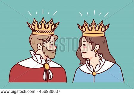 King And Queen In Mantles And Crowns Look At Each Other. Members Of Royal Family In Robes. Royalty A
