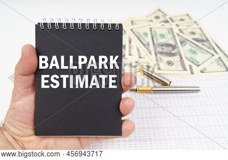 Business Concept. In The Man's Hand Is A Notepad With The Inscription - Ballpark Estimate, In The Ba