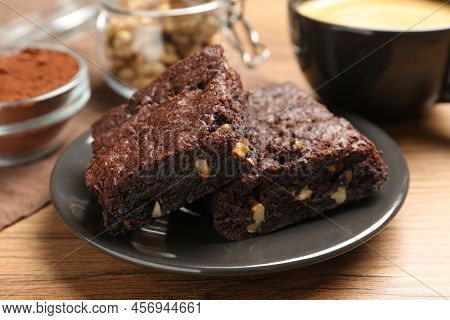 Delicious Chocolate Brownies With Nuts On Wooden Table, Closeup