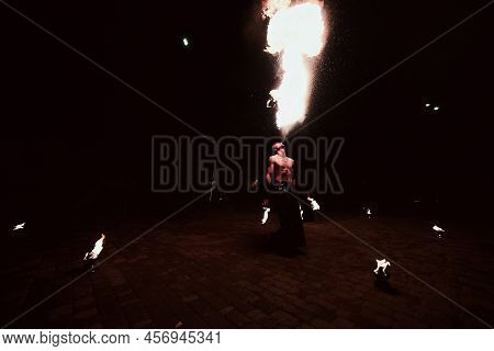 Man And Fire At Night Outdoors. Fireshow