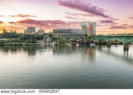 The City Skyline Of Knoxville Along The Tennessee River At Sunset