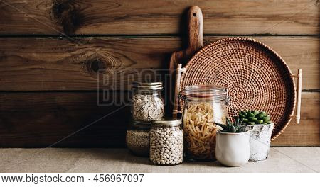 Eco-friendly Kitchen Concept: Kitchen Cooking Utensils, House Plants And Cooking Ingredients In Glas