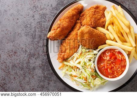 Serbian Fried Chicken With French Fries, Cabbage Salad And Hot Sauce Close Up In The Plate On The Ta