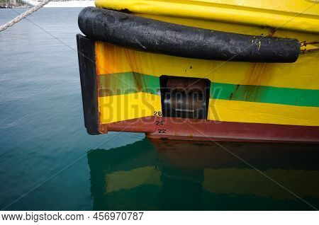 Bow Of Yellow Boat With Waterline, Fairlead, Raised Anchor, Rubber Fender And Draft Marks On Ship Bo