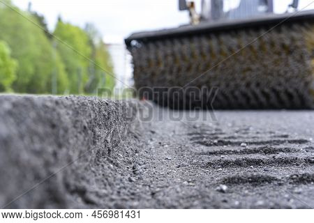 Cleaning Of Garbage From The Road With A Rotating Mechanical Machine Brush During The Repair Of The 